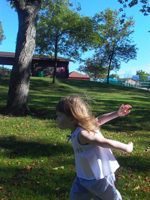 Emily running towards the swings