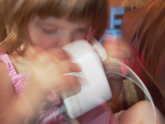 Emily finds the laptop power supply interesting